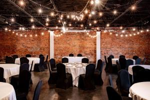 a room with tables and chairs and lights at Inn on the Square, Ascend Hotel Collection in Greenwood