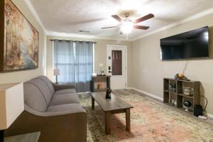 a living room with a couch and a ceiling fan at Minutes to Benning Two-Story Oasis Benning Bliss in Columbus