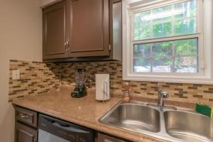 a kitchen counter with a sink and a window at Minutes to Benning Two-Story Oasis Benning Bliss in Columbus