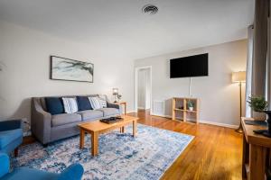 a living room with a couch and a table at 20 Mins to Downtown - Relaxing Rambler in Mobile