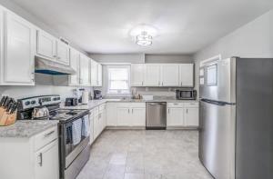 a kitchen with white cabinets and stainless steel appliances at Mins to Airport & Dining- Wonderful in Whitehaven in Memphis