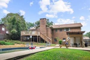 a large brick house with a pool and a deck at Two Kitchens Family Friendly in Forestdale in Birmingham