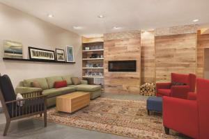 a living room with a couch and a tv at Country Inn & Suites by Radisson, Newnan, GA in Newnan