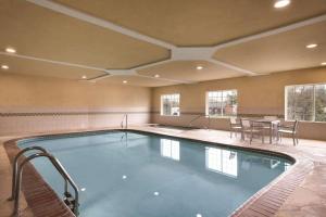 a large swimming pool with a table and chairs at Country Inn & Suites by Radisson, Valparaiso, IN in Valparaiso