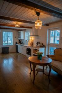 a living room with a table and a kitchen at Akureyri Old Town Home in Akureyri