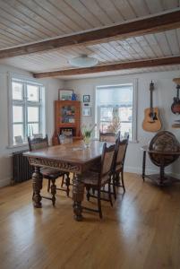 a dining room with a wooden table and chairs at Akureyri Old Town Home in Akureyri