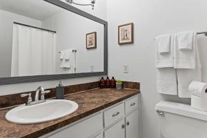 a bathroom with a sink and a mirror at Midtown Fenced Yard & Patio- White Acres Retreat in Montgomery +77 photos