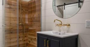 a bathroom with a sink and a shower with a mirror at Columbus First Tiny House Amenities & Charm in Columbus