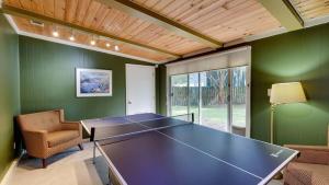 a ping pong table in a room with green walls at Halcyon Hangout-Mins to Downtown-Ping Pong-Pets in Savannah