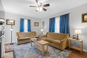 a living room with two couches and a ceiling fan at The Ridgeland Trendy Tudor-15 mins to Downtown in Chattanooga