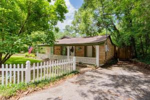 a white fence in front of a small house at Dozing on Dog River- River Access Dock Yard in Tillmans Corner