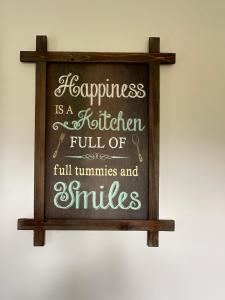 a sign that says happiness is a federation full of full tumbones and smiles at Homely Milton Keynes Stay! in Milton Keynes