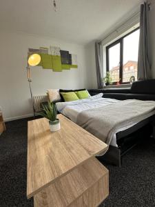 a bedroom with a bed and a table and a window at Homely Milton Keynes Stay! in Milton Keynes