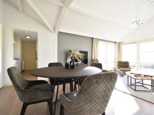 a dining room with a table and chairs at Zon en Zee in Kattendijke