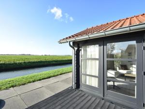 a conservatory with a view of a river at Zon en Zee in Kattendijke