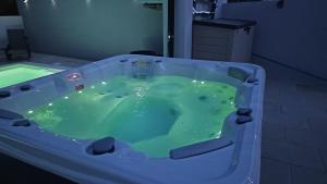 a jacuzzi tub in a bathroom with green water at Alfatima in Manteigas