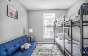a bedroom with two bunk beds and a blue couch at Cordova Colonial - Close to I-40 in Memphis