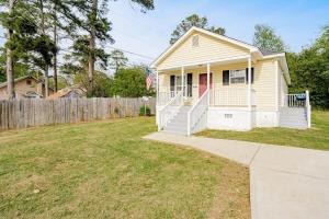 a small white house with a fence and a yard at Close to USC & Midtown-Downtown - Newly Renovated in Columbia