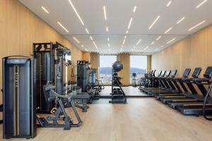 a gym with rows of treadmills and machines at Courtyard by Marriott Fukui in Fukui
