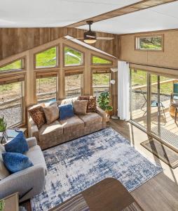 a living room with a couch and a rug at Big-Tiny Home Farm Stay-15Min to Chattanooga in Wildwood
