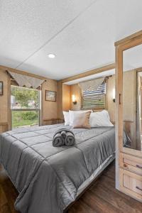 a bedroom with a large bed with two towels on it at Big-Tiny Home Farm Stay-15Min to Chattanooga in Wildwood