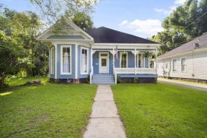 a blue house with a lawn in front of it at The Mardis Gras Manor Walkable, Historic, Local Treasure in Mobile
