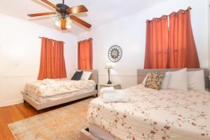 a bedroom with two beds and a ceiling fan at The Parkside Cottage Lakebottom Park at Doorstep! in Columbus
