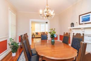 a dining room with a wooden table and chairs at The Parkside Cottage Lakebottom Park at Doorstep! in Columbus