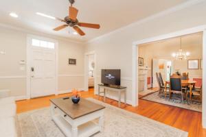 a living room with a ceiling fan and a table at The Parkside Cottage Lakebottom Park at Doorstep! in Columbus