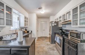 a large kitchen with stainless steel appliances and white cabinets at Near Dining Shopping Parks Tranquil Fox Trails in Memphis
