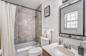 a white bathroom with a sink and a toilet and a tub at Near Dining Shopping Parks Tranquil Fox Trails in Memphis +52 photos