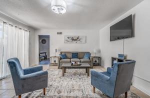 a living room with a couch and chairs and a table at Near Dining Shopping Parks Tranquil Fox Trails in Memphis