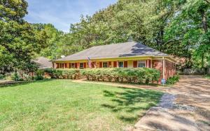 a house with a flag in a yard at Near Dining Shopping Parks Tranquil Fox Trails in Memphis