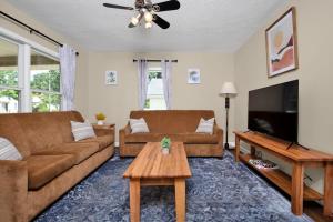 a living room with two couches and a tv at The Precious Pearl- Close to downtown, Ft Bragg, in Fayetteville
