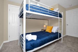 a bedroom with two bunk beds with blue sheets at The Precious Pearl- Close to downtown, Ft Bragg, in Fayetteville