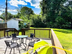 a patio with a table and chairs on a deck at Bright Bonita Bungalow-Yard-Deck-Medical District in Huntsville