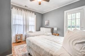 a bedroom with two beds and a window at 10 Min to U of Memphis-Rozelle Retreat Both Units in Memphis