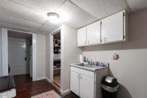 a kitchen with white cabinets and a sink at Redmont Revival-Unit B-Walkable-UAB in Birmingham