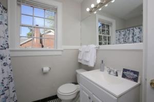 a white bathroom with a toilet and a sink at Lovely on Lorick-USC, Jackson, Pets, Wifi in Columbia +37 photos