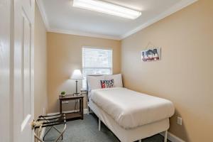 a small bedroom with a bed and a window at Sunny Side at Dog River-Dock, Lake, Fenced Yard in Mobile