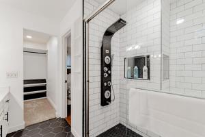 a bathroom with a shower and a white tile wall at Settle Inn-- 10mi to Columbia, Mins to Lake Murray in Irmo +60 photos