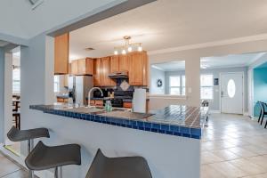 a kitchen with a blue tile counter top at Sunny Side at Dog River-Dock, Lake, Fenced Yard in Mobile
