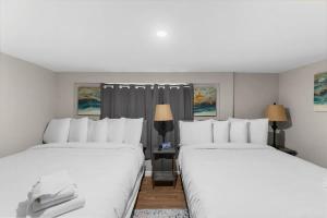 2 camas en una habitación de hotel con almohadas blancas en Near Hospital & Dining- Beds on Broadmoor - Unit B, en Birmingham