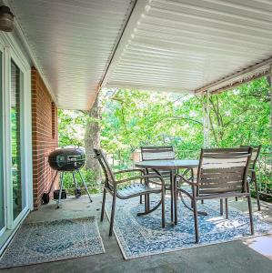 a patio with a table and chairs and a grill at Mins to Zoo Hospital & UA - Broadmoor Bungalow in Little Rock