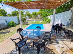 a patio with a table and chairs and a pool at Casa Ferriño in Cuatrociénegas de Carranza