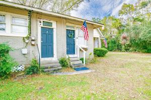 a house with a blue door and two american flags at Charming Midtown Apt - Hannon Hideaway Unit B in Mobile