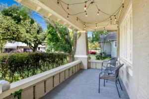 a porch with chairs and awning and a house at Charming Midtown Apt - Hannon Hideaway Unit C in Mobile