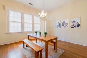 a dining room with a wooden table and a chandelier at Near Downtown Parks & Museum - Midtown Two-Units in Columbus