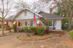 a white house with an american flag in front of it at Near Downtown Parks & Museum - Midtown Two-Units in Columbus