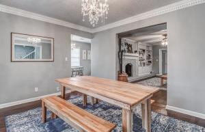 a dining room with a wooden table and a chandelier at Happy on Haddington- Easy access to I-240 in Memphis